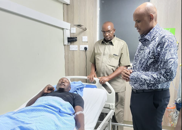 DCI boss Mr Mohamed Amin visits one of the officers who was injured.